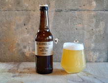 Load image into Gallery viewer, Bottle and glass of beer labeled 'The Kerne India Pale Ale - Galaxy, SImcoe, Citral' on a wooden surface with a concrete wall background.